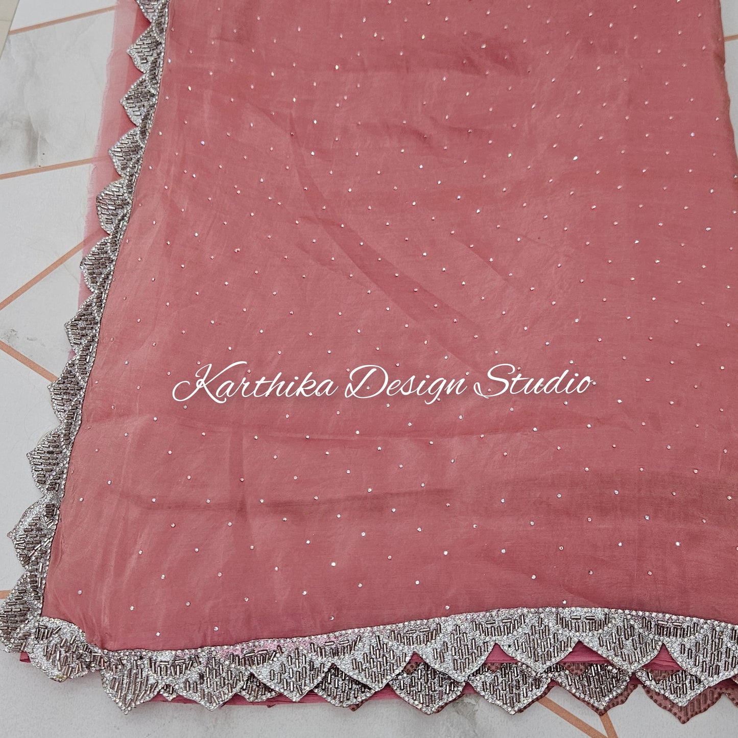 Onion pink Jimmy Choo saree with cutwork border and attached blouse piece
