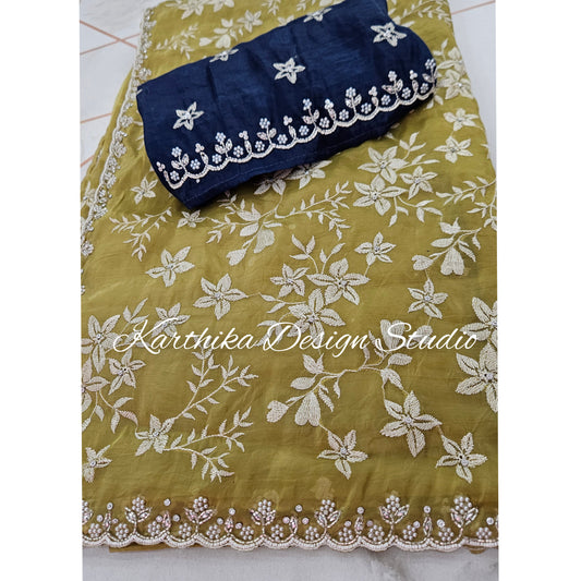 Olive green Jimmychoo saree with cutwork border and overall embroidery