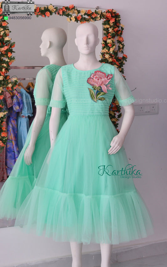 Pleated net frock with applique work
